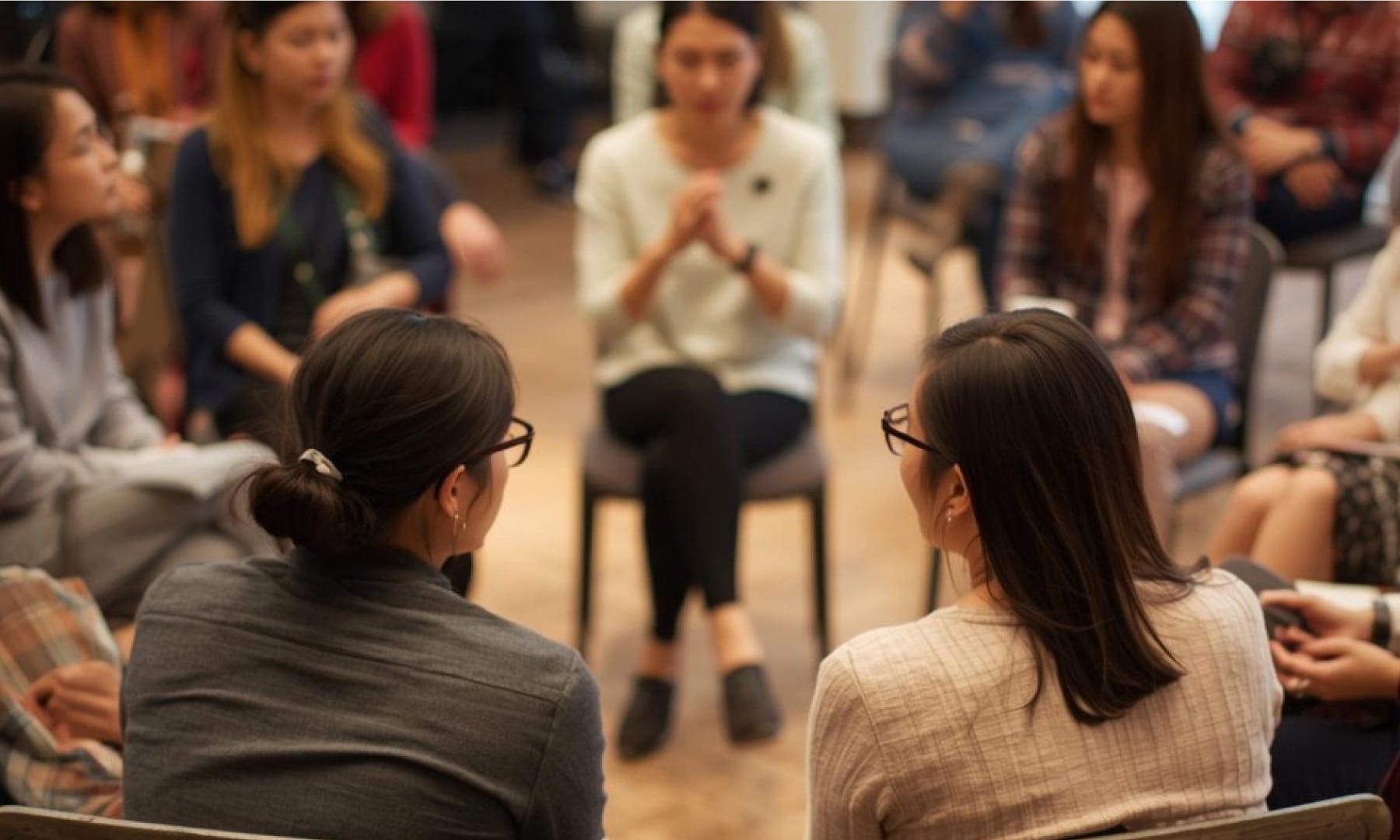 Image of people seated in a circle